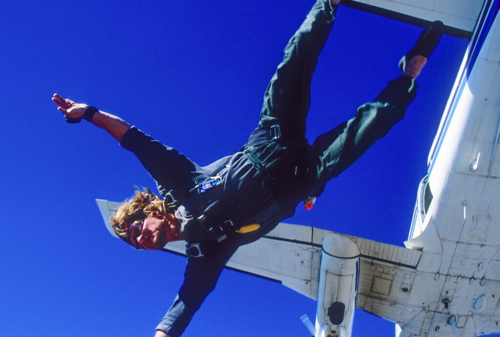 Aerial cinematographer filming skydivers in formation