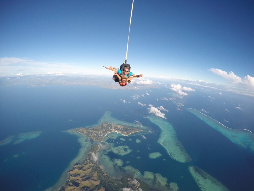 Aerial view of Fijian islands and coral reefs from skydiving altitude