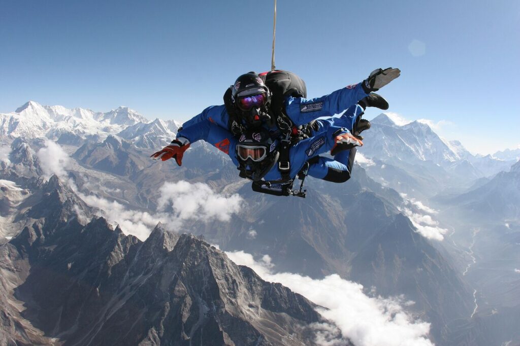 Diver with snow-covered peaks below.