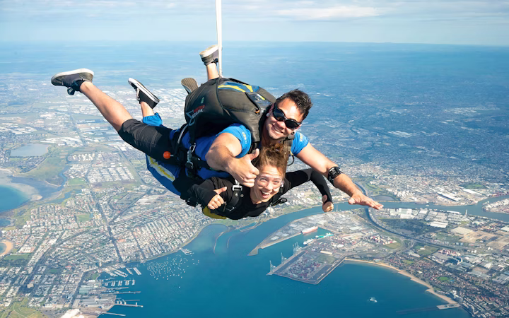 Skydiver above African coastline with wildlife visible below