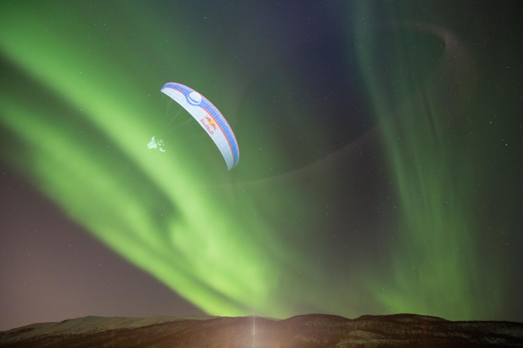Skydiver with aurora borealis visible in background