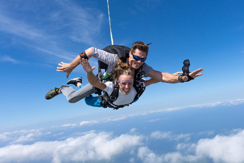 Student doing first tandem jump with instructor, showing proper body position