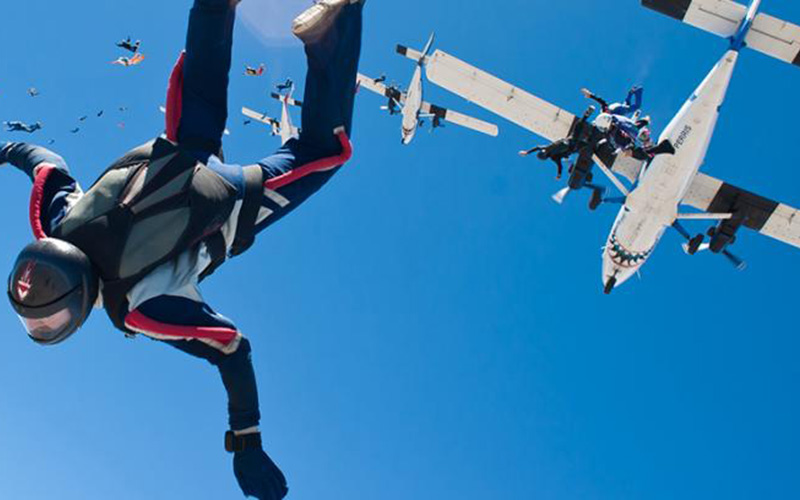 Ground-level view of Skydive Abu Dhabi terminal building with aircraft on tarmac